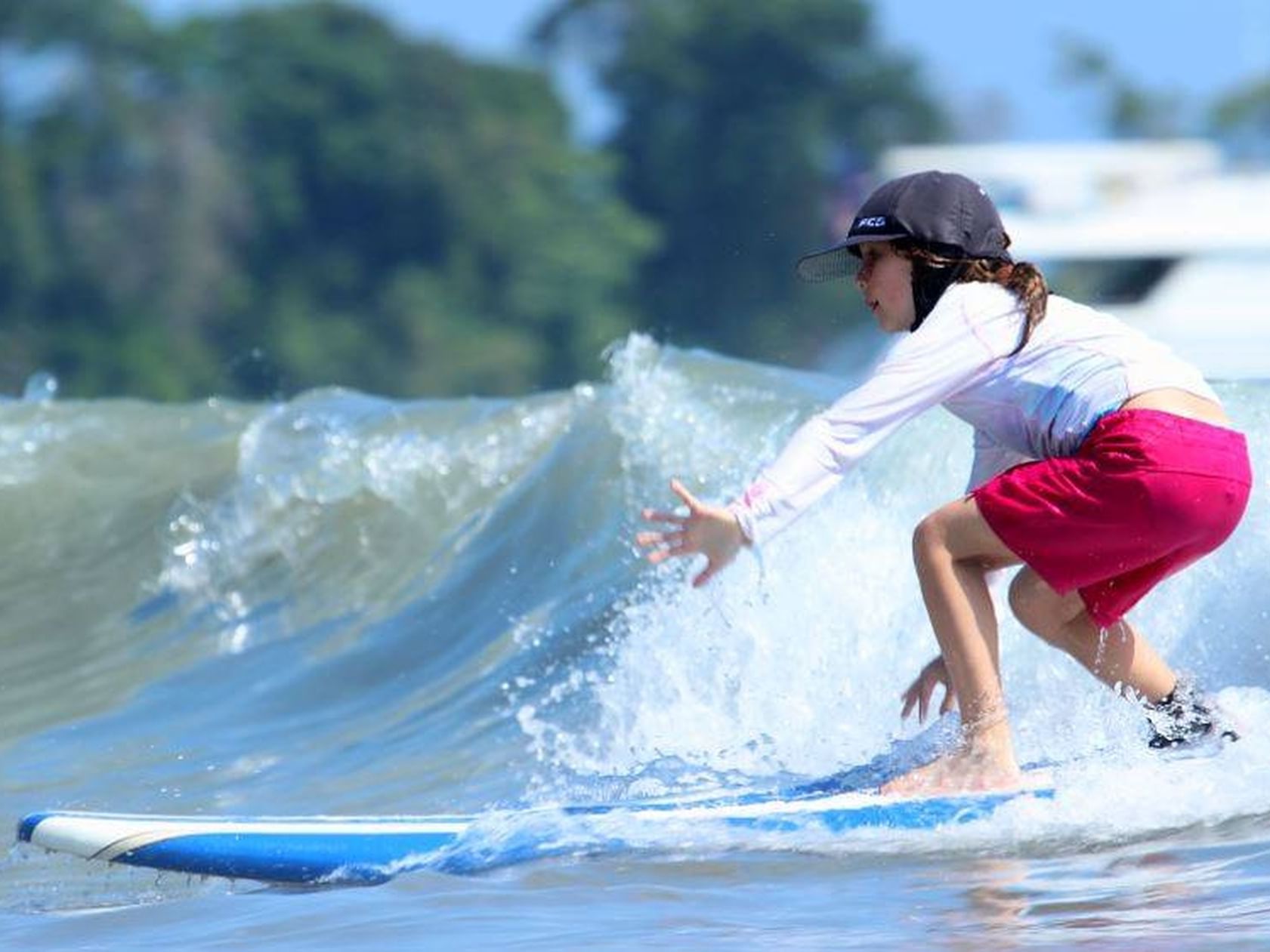 Little girl practicing surfing in the beach near Jungle Vista Boutique Hotel