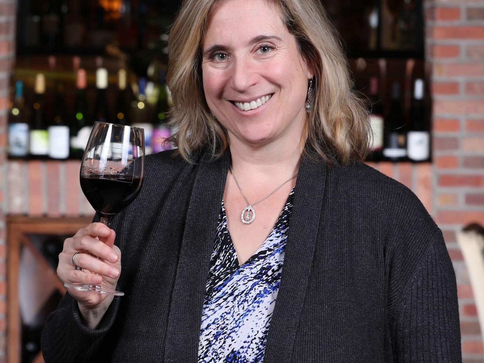 Laura Winter Falk with a wine glass at La Tourelle Hotel & Spa