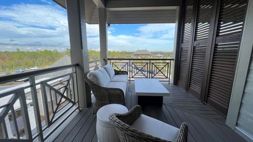 Balcony lounge area overlooking the land in King Room With Balcony at Camp Creek Inn