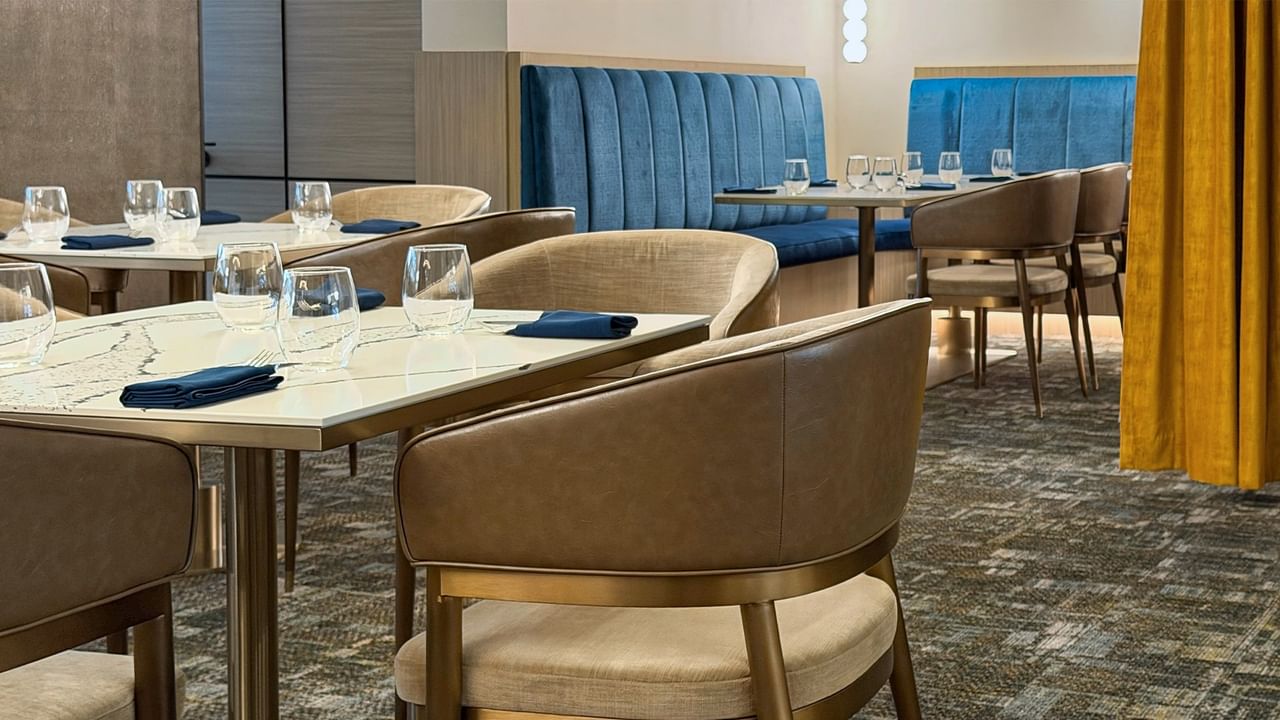 Restaurant dining area with chairs and set tables.