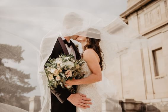 Bride & groom kissing at Carlton Hotel Singapore