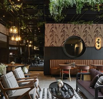 Cafe interior with plush seating and ornaments in Winter Garden at Titanic Comfort Kurfürstendamm