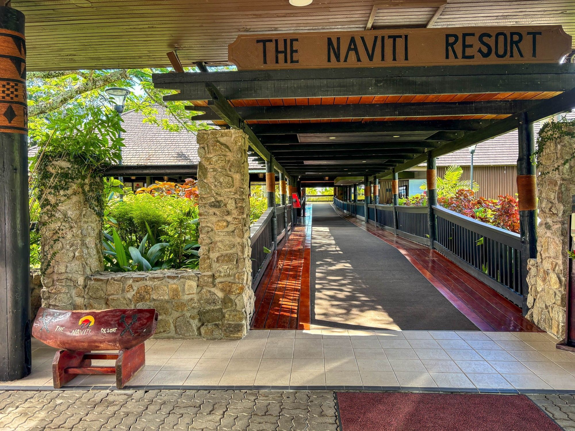The Naviti Resort entrance with a long walkway and tropical surroundings at Naviti Resort Fiji Coral Coast كورال كوست