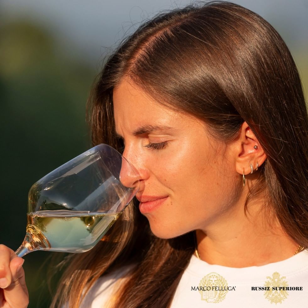 Woman smelling wine in a glass from the PURO Wine Collection.