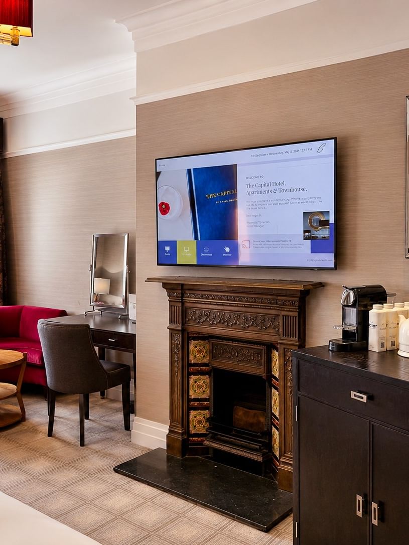 Elegant Deluxe King room with fireplace, desk, and modern amenities at The Capital Hotel, Apartments & Townhouse - London.