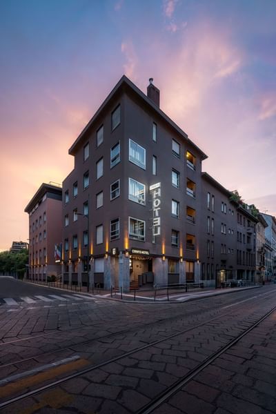 Exterior of the hotel with street view & sign featuring Hotel Crivi's in Milan