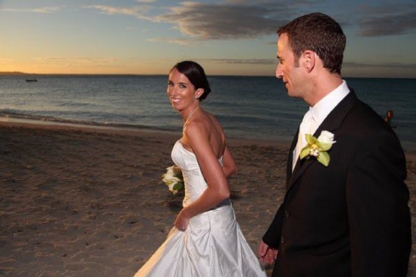 Couple walking by the beach at The Somerset on Grace Bay