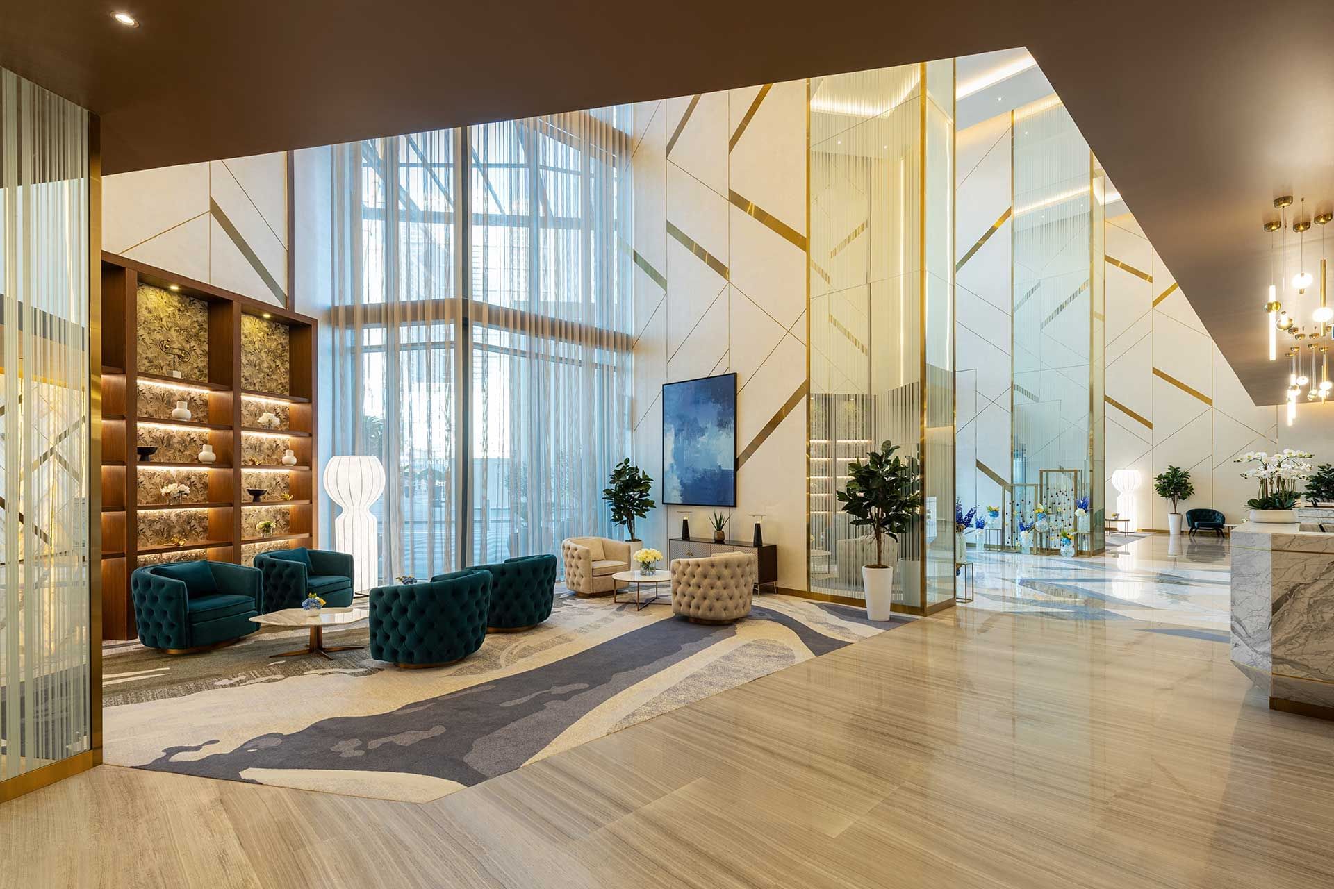 Lobby with marble reception desk, vertical light strips and elegant decor at DAMAC Maison AYKON City, luxury resorts in Dubai