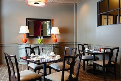 Two dining tables in the restaurant at Ethan Allen Hotel