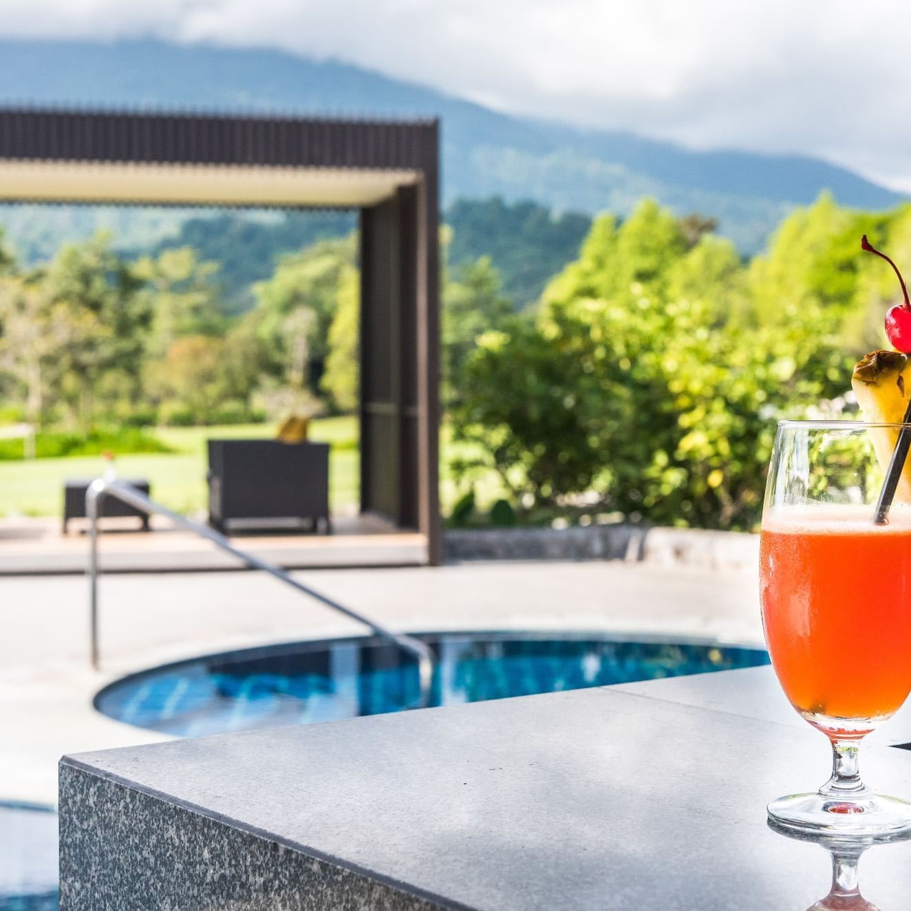 A cocktail near a pool in Chatrium Golf Resort at Soi Dao