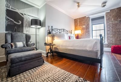 Comfy bed with a sofa in River View Room with King Bed at River Street Inn