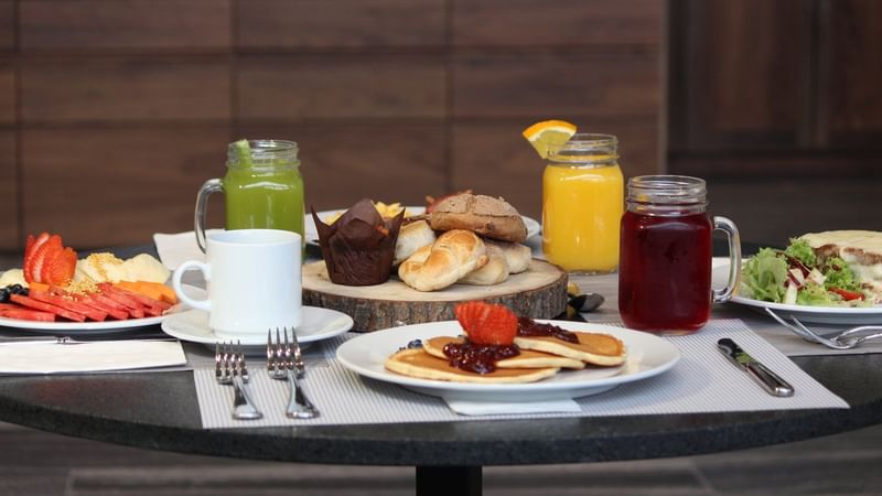 A beautifully arranged breakfast spread on a table at Fiesta Inn Suites Aeropuerto Del Bajío