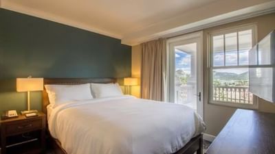 Aspire two bedroom suite with a queen sized bed, private balcony and bedside lamps at The Stanley Hotel