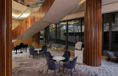 Lower lobby lounge area by a stairway at Amora Hotel Sydney