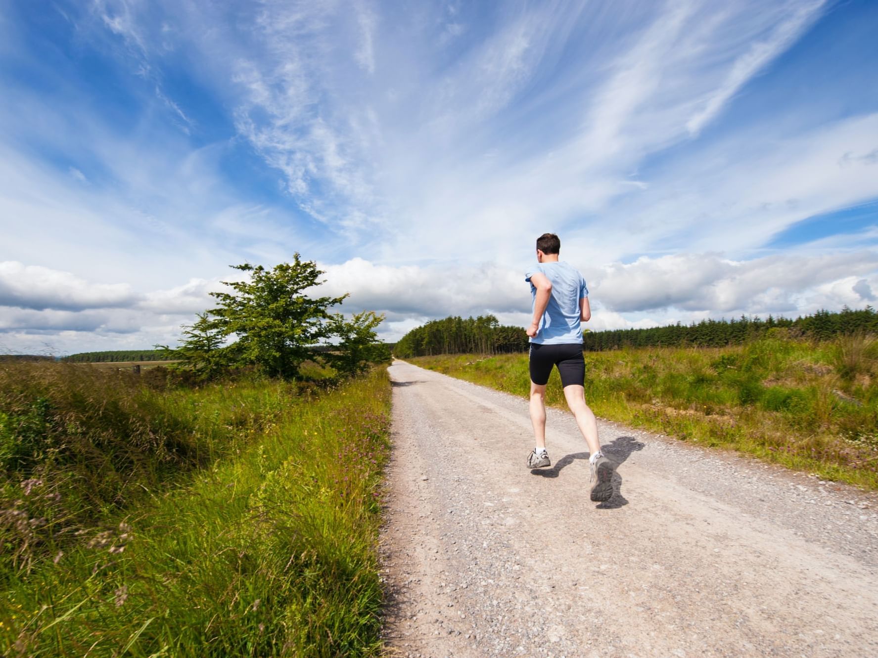 A man running on track in Bernay near The Originals Hotels