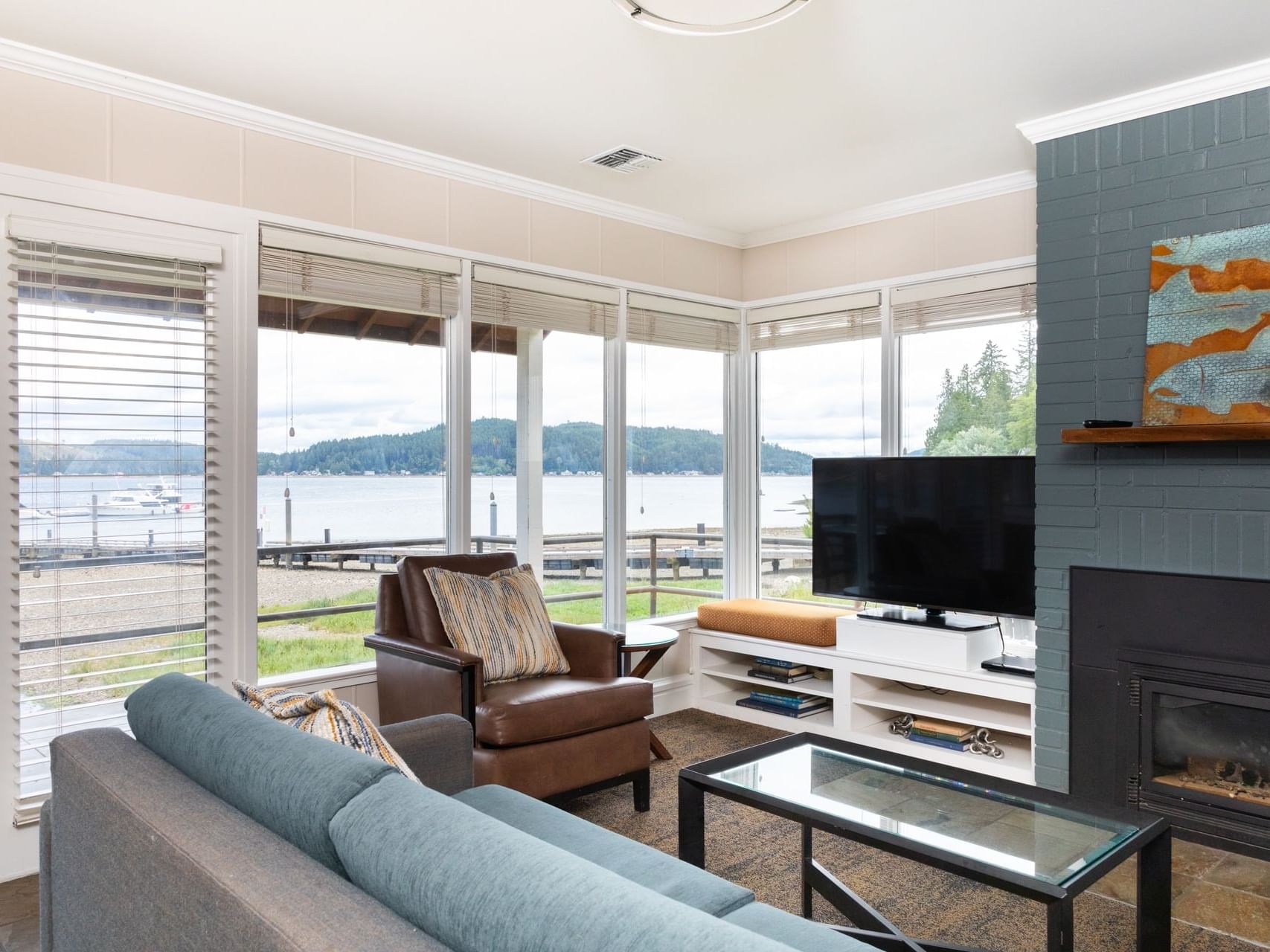 Spacious living area with cozy couches and a TV in Waterfront Cottage at Alderbrook Resort & Spa
