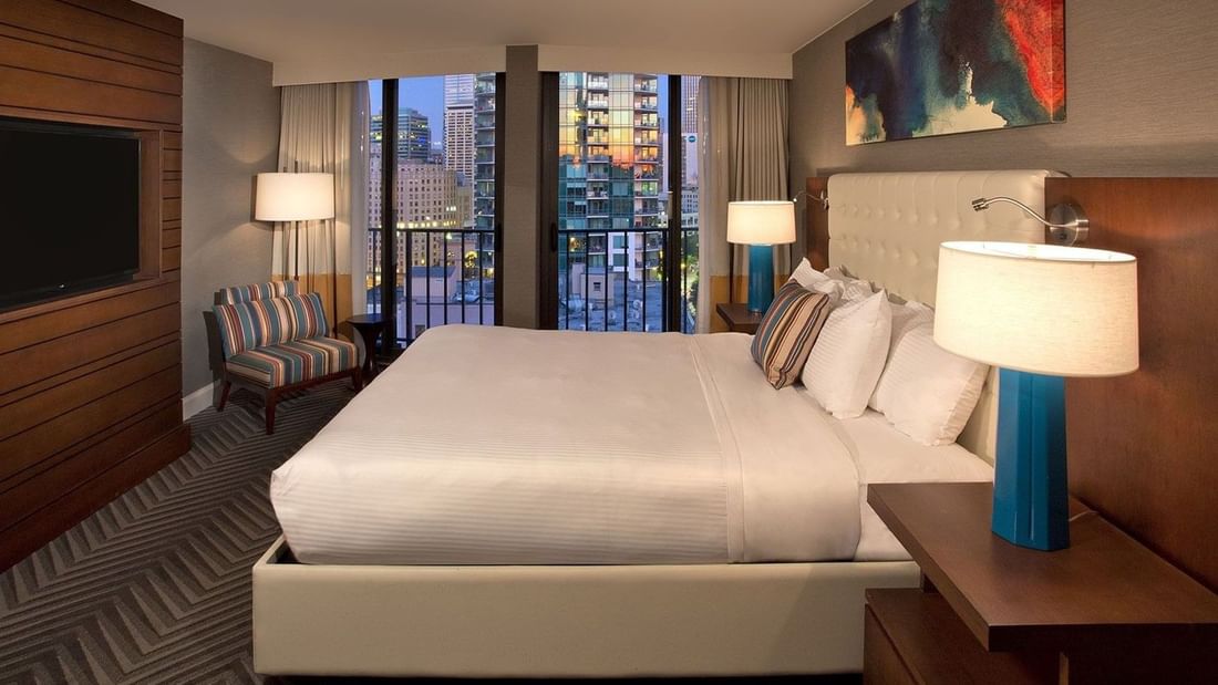 Evergreen Suite at Warwick Seattle in Seattle with large bed, modern decor, and city view.