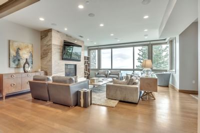 Living room with a modern interior & wooden floor of an apartment at Stein Eriksen Residences