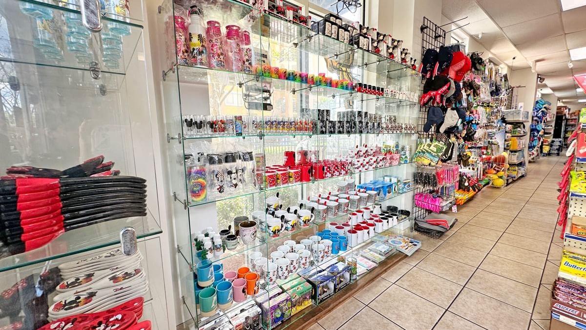 A convenience store with glass shelves stocked with various products