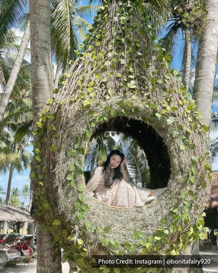 A woman was sitting in the bird nest at Kampung Agong - Lexis Suites Penang