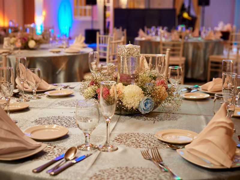 Close-up of a wedding table arrangement with glassware at Fiesta Americana