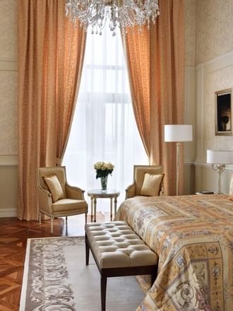 Bedroom with bed, Tv & sitting area at Palazzo Versace Dubai 