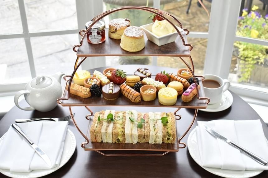 Afternoon Tea at Gorse Hill in Woking featuring mini cakes, finger sandwiches, scones and tea 