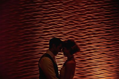 A bride & groom in front of an elegant wall at Matrix Hotel