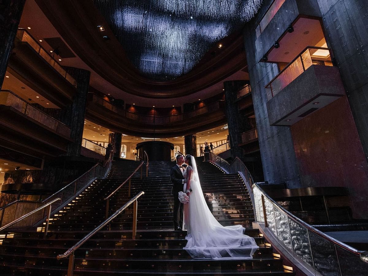 Zina & Cristian Kissing each other on stairs at Crown Hotels
