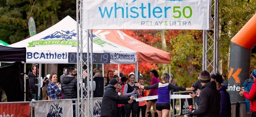 Runner crossing the finish line at the Whistler 50 Relay & Ultra