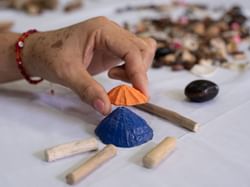 A lady making crafts out of sea shells at Punta Islita Hotel
