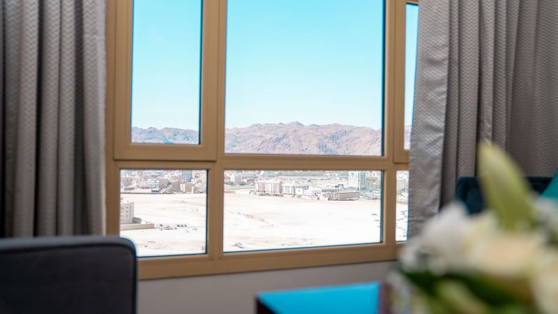 View from an Executive King Room window overlooking the city and mountains at Saja by Warwick Madinah.