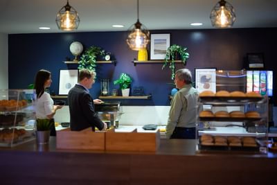 People grabbing food from a modern buffet counter during a delicious rodd moncton breakfast morning routine