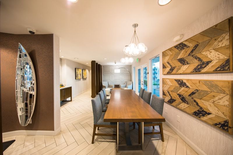 Dining room with long wooden table & interior at SeaCrest Oceanfront Hotel Pismo Beach