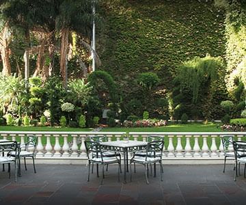 Patio tables in the garden at Hotel Emperador Buenos Aires