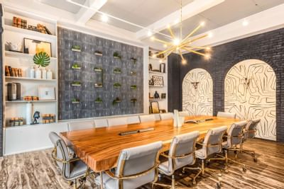 Conference-type event room set-up with artistic wall designs and wooden floors at The Riverwalk Plaza Hotel