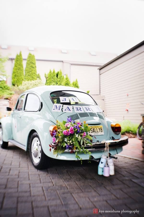 Light blue vintage Volkswagen Beetle decorated with flowers and Just Married sign at Aramark Chauncey Conference Center