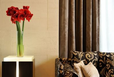 Beautiful flower vase by a sofa at Uptown Palace in Milan