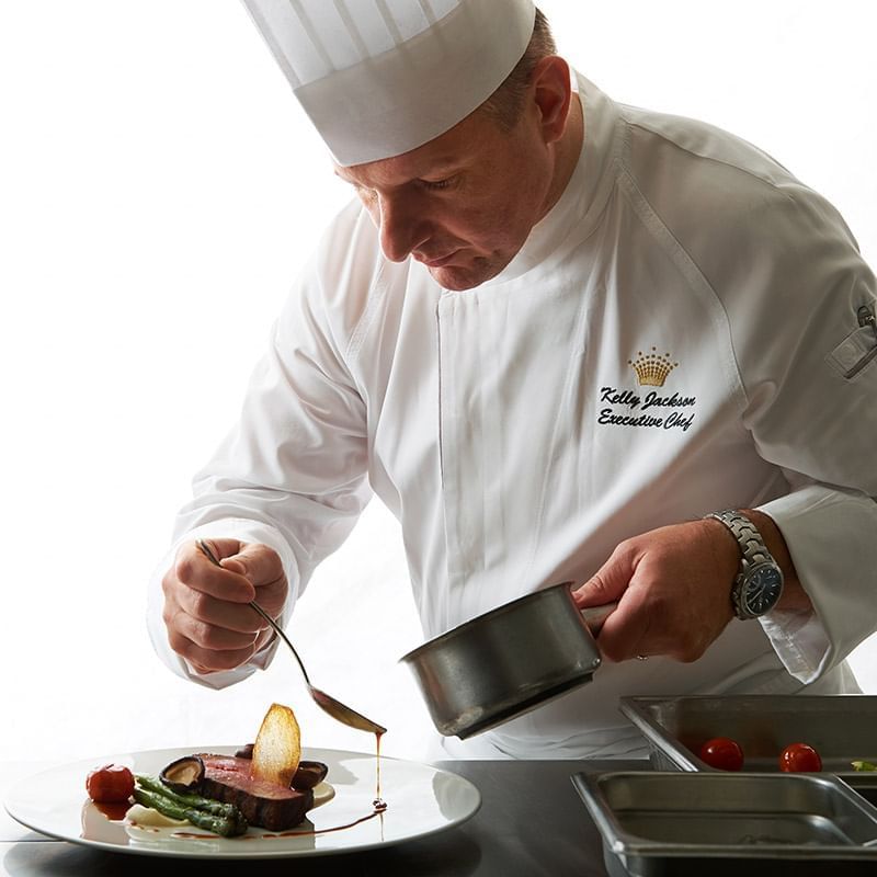 Portrait of a chef plating a dish at Crown Hotel Melbourne