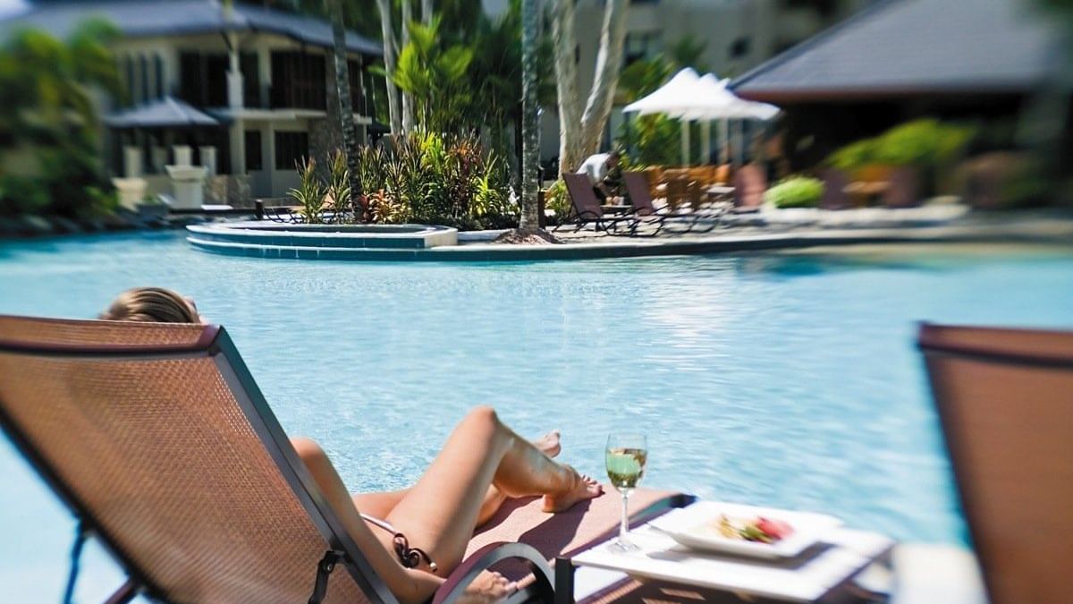 Pool relaxation with food at Pullman Palm Cove Sea Temple Resort & Spa