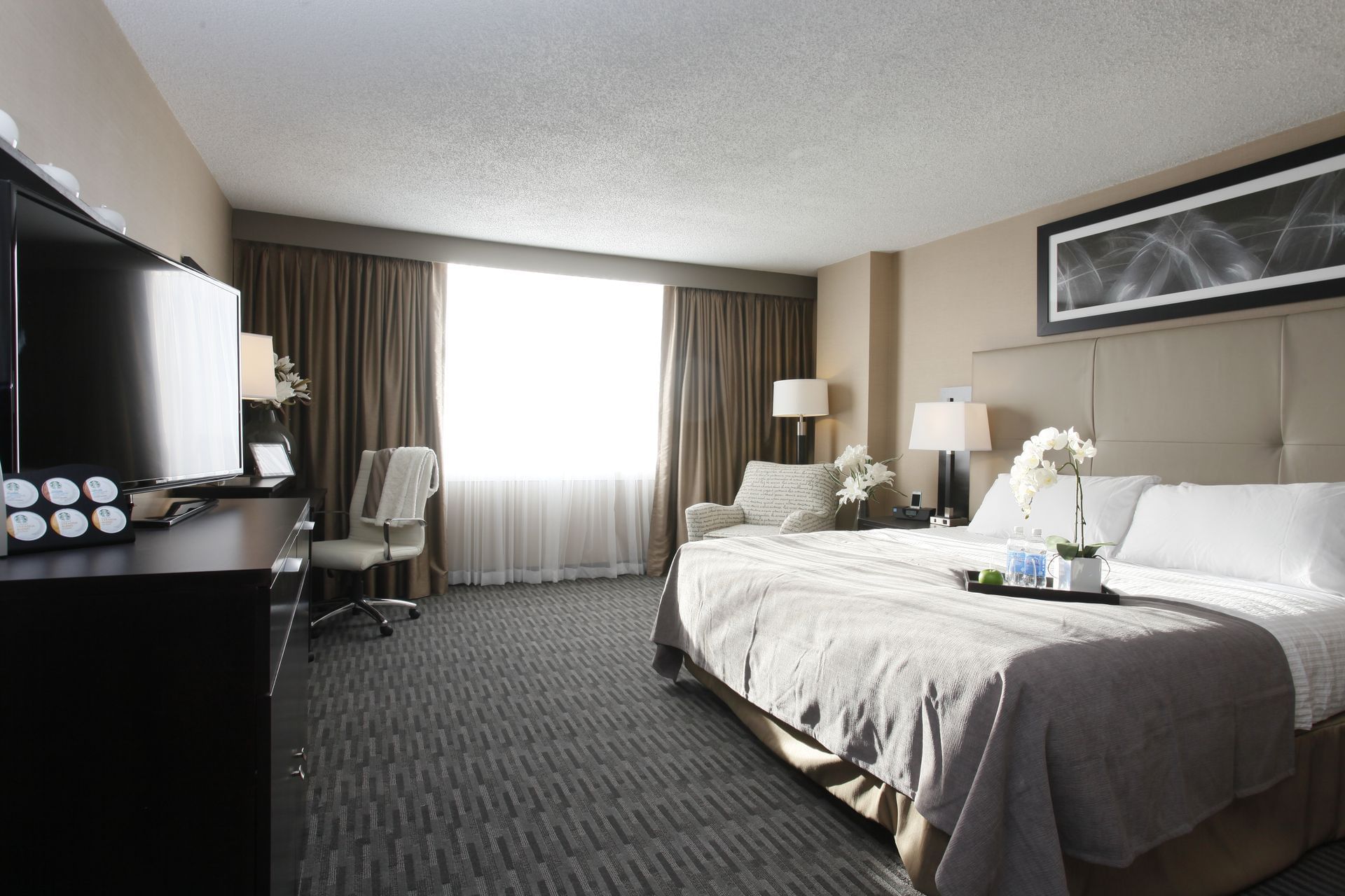 a bed facing a tv in a hotel room