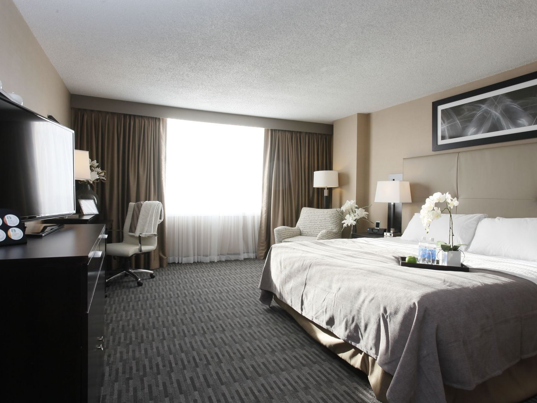 a bed in a hotel room facing a tv