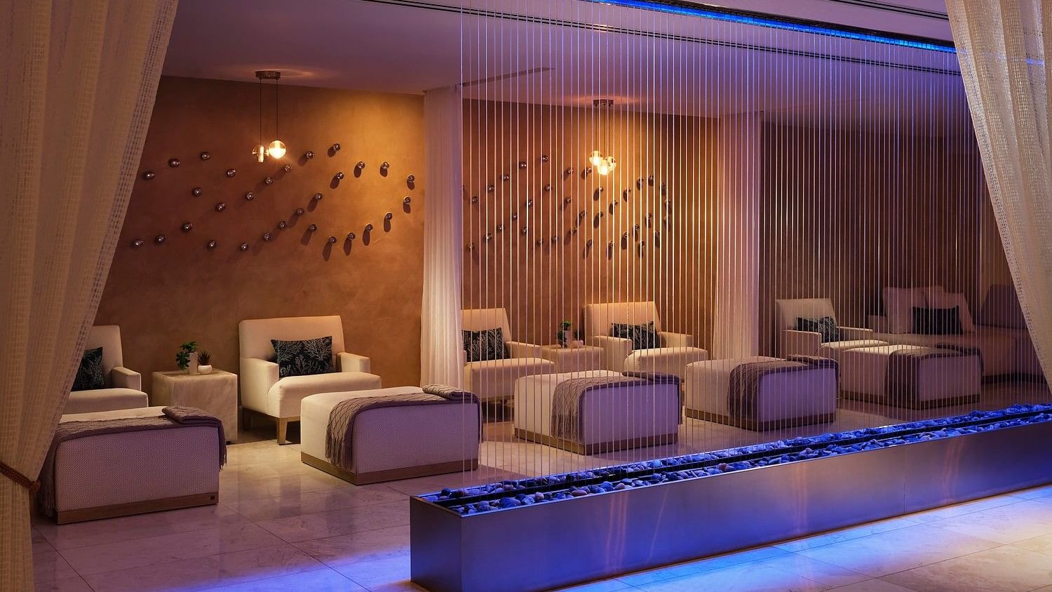 Luxury spa relaxation lounge with plush seating and tranquil design.