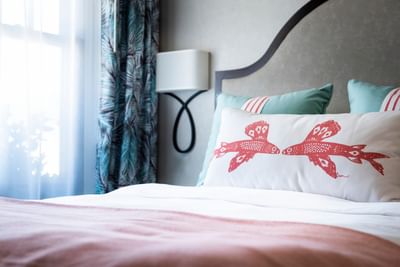 Nightstand by the king-size bed in the hotel room at Hotel Atwater