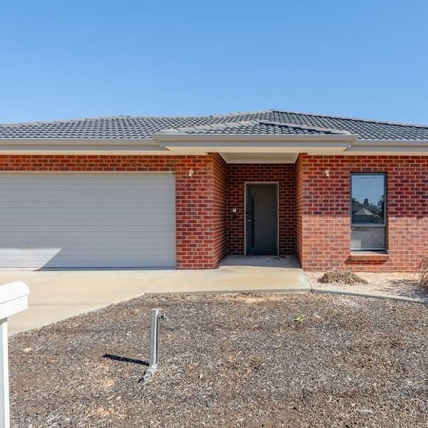 Exterior view of a brick house with garage and driveway at La Trobe University Regional Housing – Mildura.