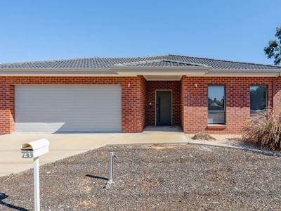 Exterior view of a brick house with garage and driveway at La Trobe University Regional Housing – Mildura.
