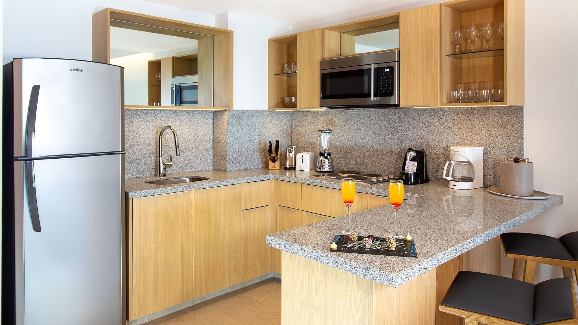 Modern Premium Suite kitchen at Sunset Plaza Beach Resort & Spa, one of the top Puerto Vallarta hotels, with a granite bar