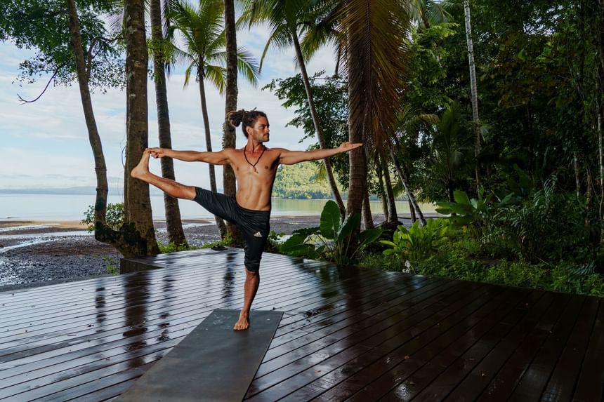 Man doing yoga in outdoor at Playa Cativo Lodge