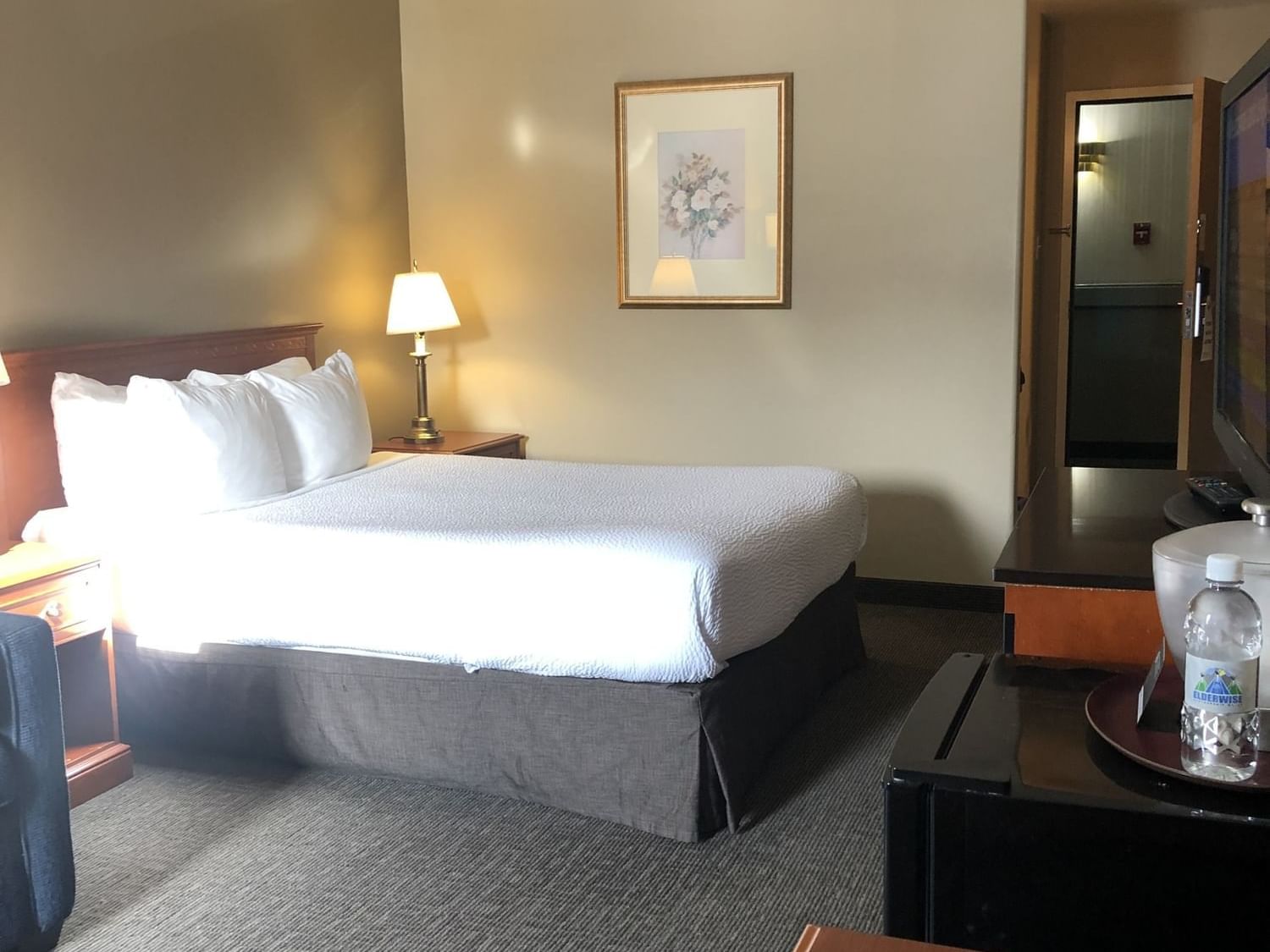 Cozy bed and carpeted floor in Superior Plus One Queen at Nomad Hotel Fort McMurray