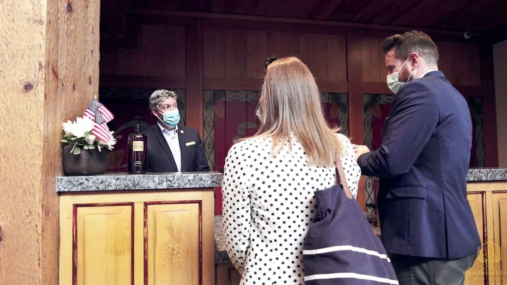 Guests with Hotel receptionist at check-in of Chateaux Deer Valley